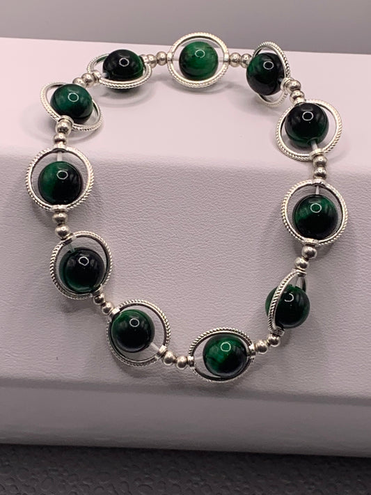 Green tigers eye semi precious stone/crystal elastic beaded bracelet with silver colored rings