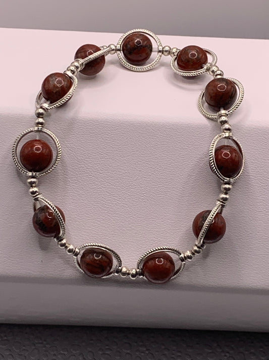 Red sesame jasper semi precious stone/crystal elastic beaded bracelet with silver colored rings