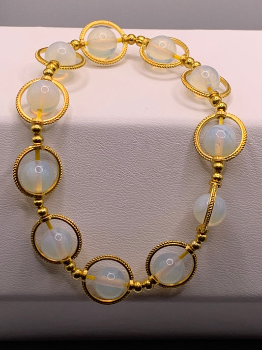 Opalite semi precious stone/crystal elastic beaded bracelet with gold colored rings