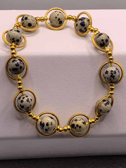Dalmatian jasper semi precious stone/crystal elastic beaded bracelet with gold colored rings