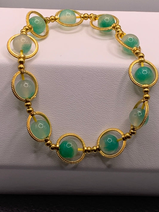 Mint green chalcedony semi precious stone/crystal elastic beaded bracelet with gold colored rings