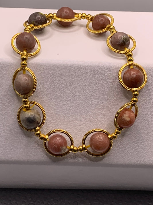 Pink lepidolite semi precious stone/crystal elastic beaded bracelet with gold colored rings