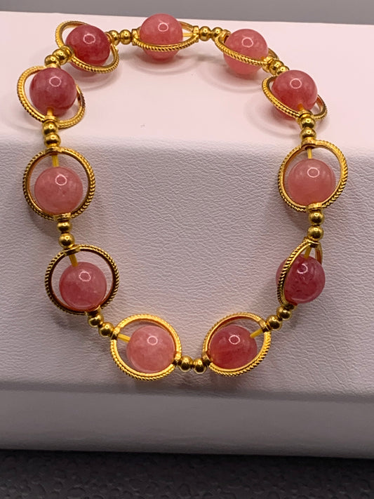 Pink chalcedony semi precious stone/crystal elastic beaded bracelet with gold colored rings