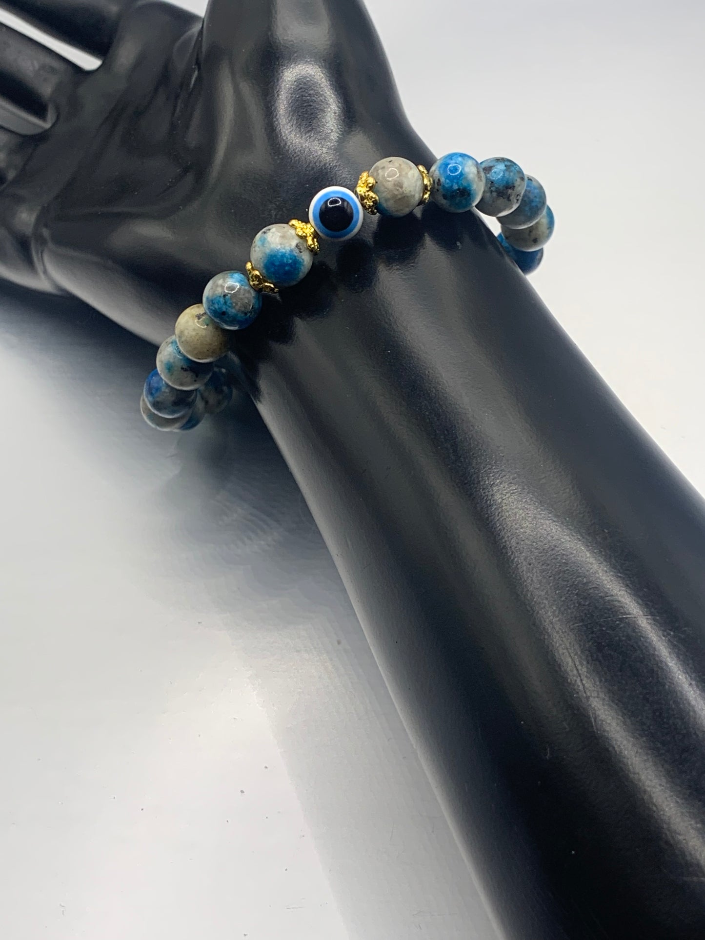 This bracelet features k2 jasper beads and a colorful evil eye resin bead with gold flower caps. These are 8mm beads, made with elastic string to stretch onto the wrist and is approximately 17 cm or 6.7 inches


These are natural semi-precious stones/crystals. Even if they are dyed, the base material is still natural and imperfections are common making them unique.