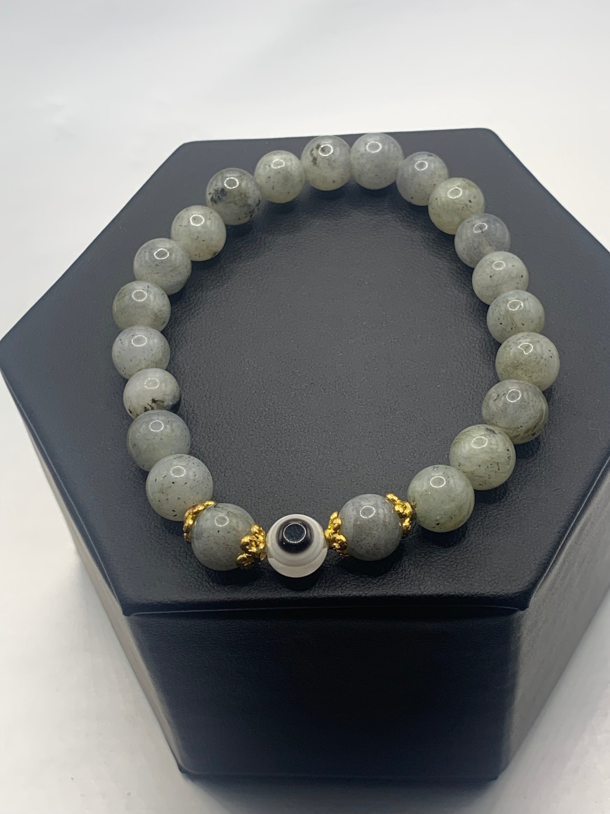 This bracelet features labradorite beads and a colorful evil eye resin bead with gold flower caps. These are 8mm beads, made with elastic string to stretch onto the wrist and is approximately 17 cm or 6.7 inches



These are natural semi-precious stones/crystals. Even if they are dyed, the base material is still natural and imperfections are common making them unique