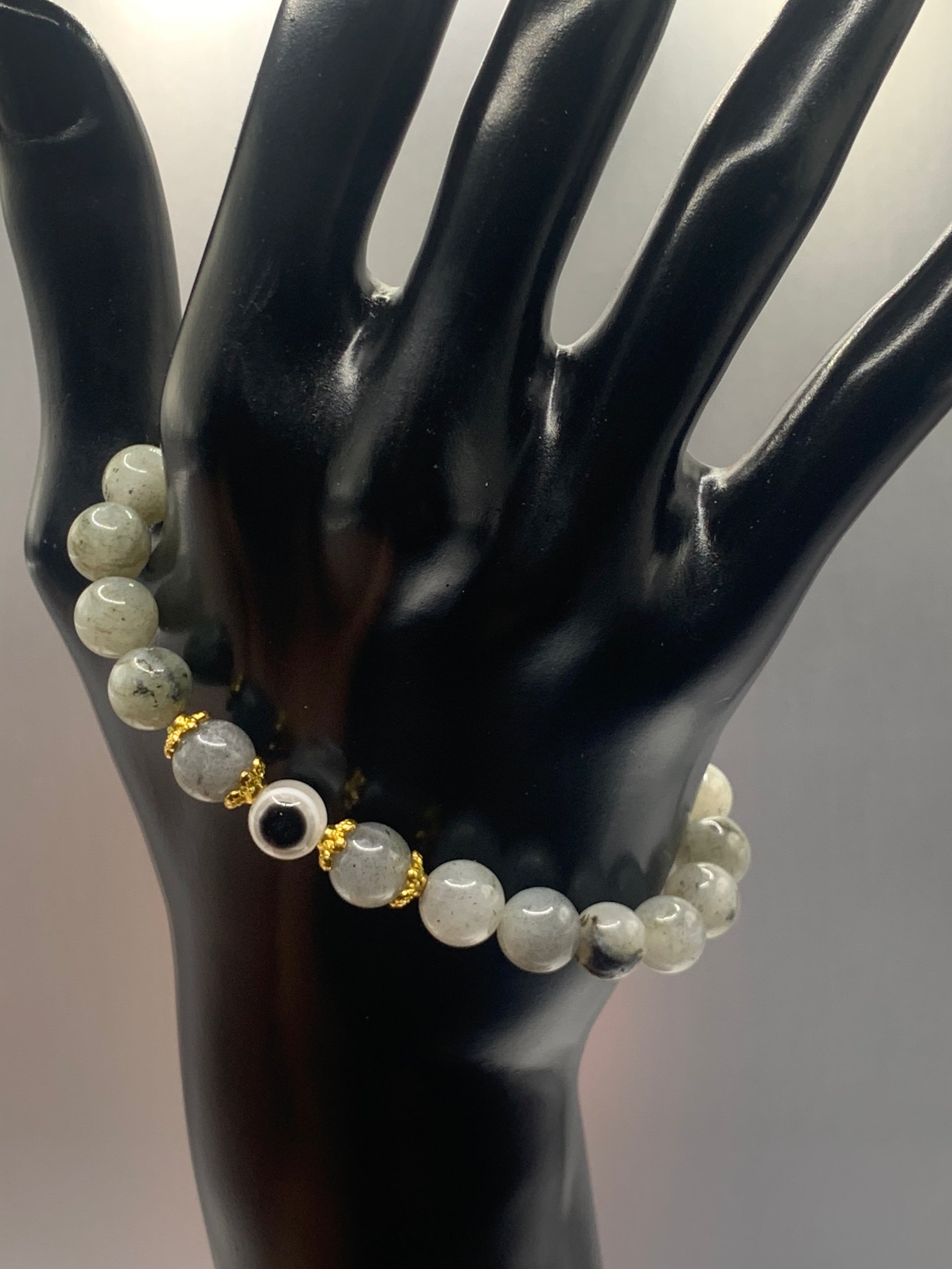 This bracelet features labradorite beads and a colorful evil eye resin bead with gold flower caps. These are 8mm beads, made with elastic string to stretch onto the wrist and is approximately 17 cm or 6.7 inches



These are natural semi-precious stones/crystals. Even if they are dyed, the base material is still natural and imperfections are common making them unique