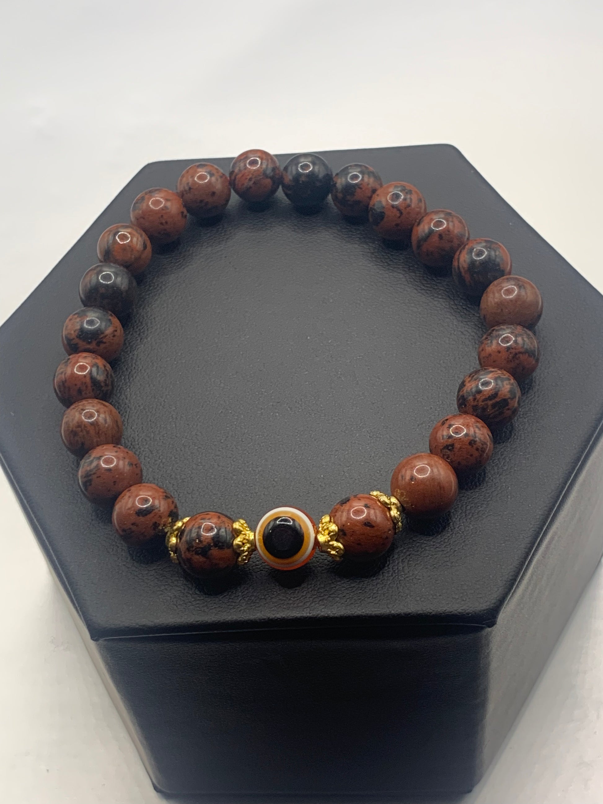 This bracelet features mahogany jasper beads and a colorful evil eye resin bead with gold flower caps. These are 8mm beads, made with elastic string to stretch onto the wrist and is approximately 17 cm or 6.7 inches



These are natural semi-precious stones/crystals. Even if they are dyed, the base material is still natural and imperfections are common making them unique