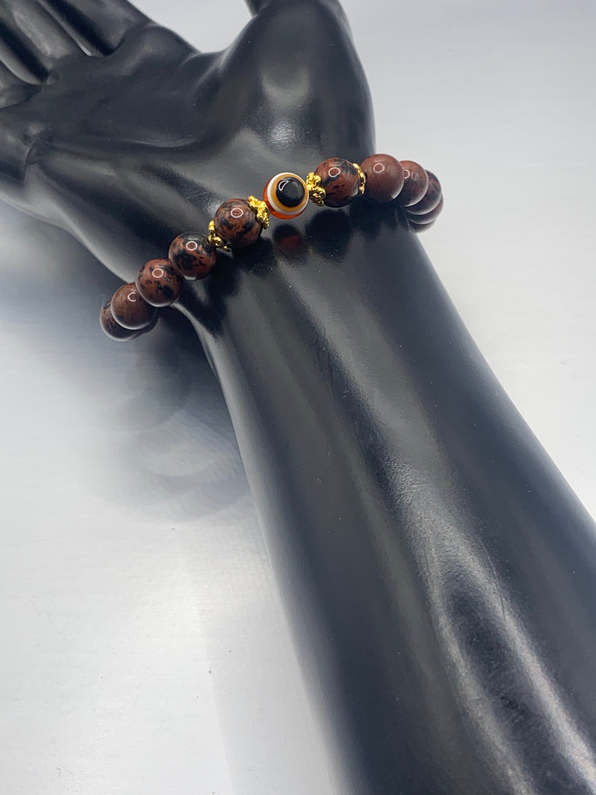 This bracelet features mahogany jasper beads and a colorful evil eye resin bead with gold flower caps. These are 8mm beads, made with elastic string to stretch onto the wrist and is approximately 17 cm or 6.7 inches



These are natural semi-precious stones/crystals. Even if they are dyed, the base material is still natural and imperfections are common making them unique