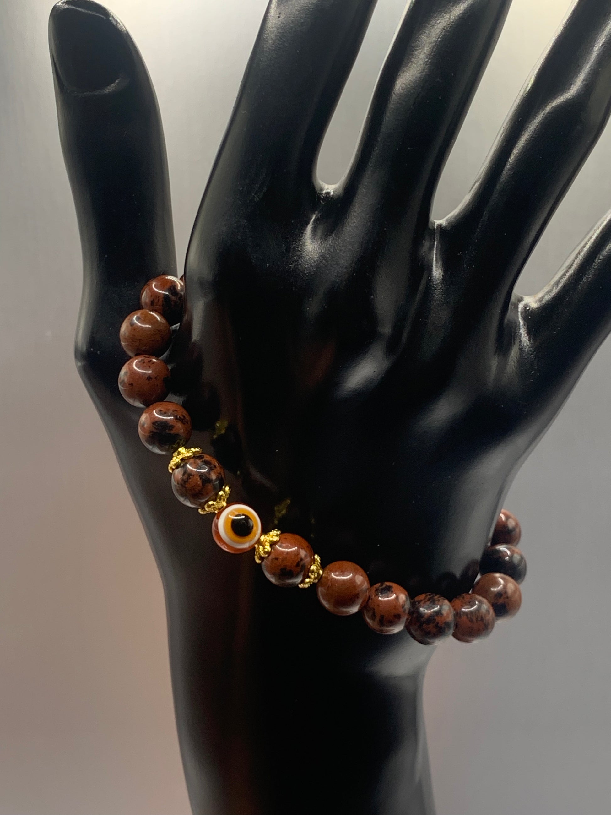 This bracelet features mahogany jasper beads and a colorful evil eye resin bead with gold flower caps. These are 8mm beads, made with elastic string to stretch onto the wrist and is approximately 17 cm or 6.7 inches



These are natural semi-precious stones/crystals. Even if they are dyed, the base material is still natural and imperfections are common making them unique