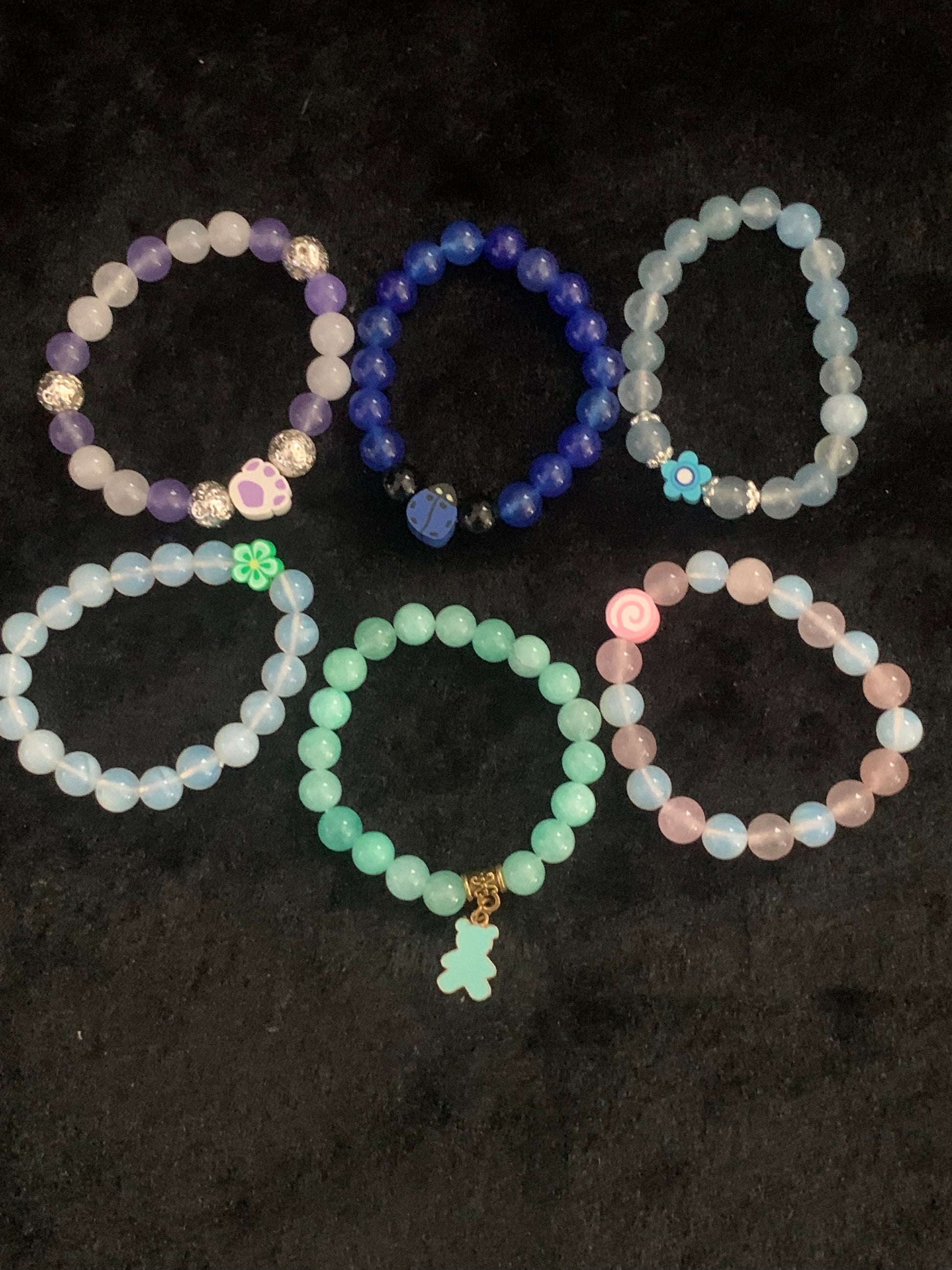 Set of colorful beaded bracelets on a dark background
