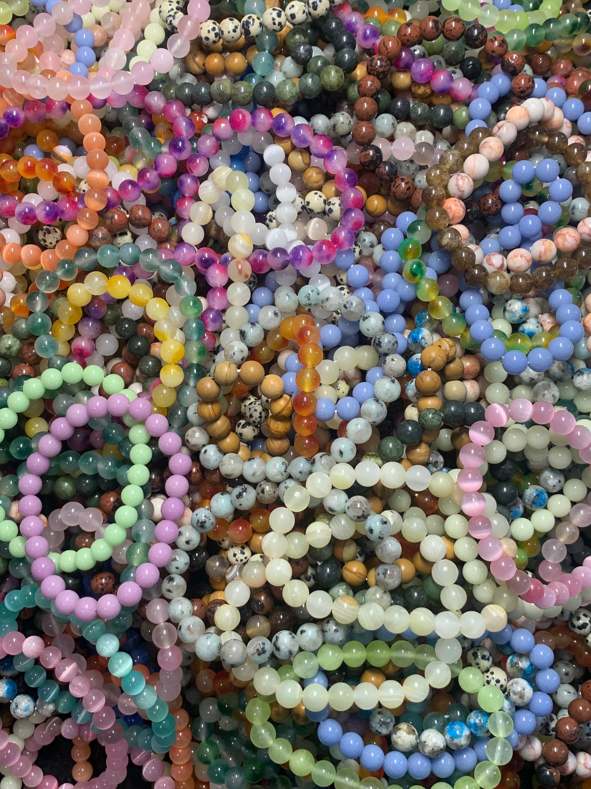 Collection of colorful beaded bracelets on a textured surface