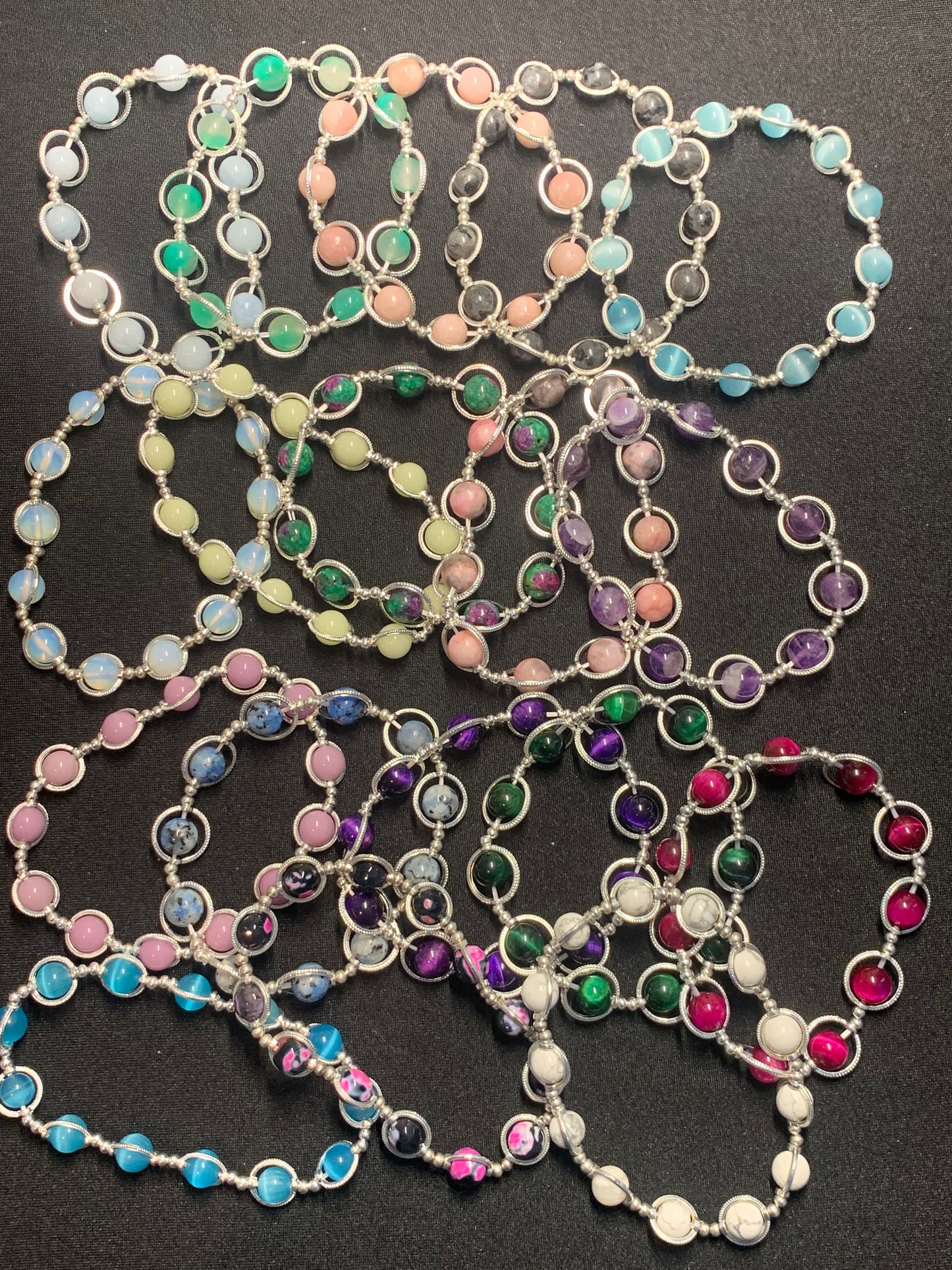 Colorful beaded necklaces on a black background