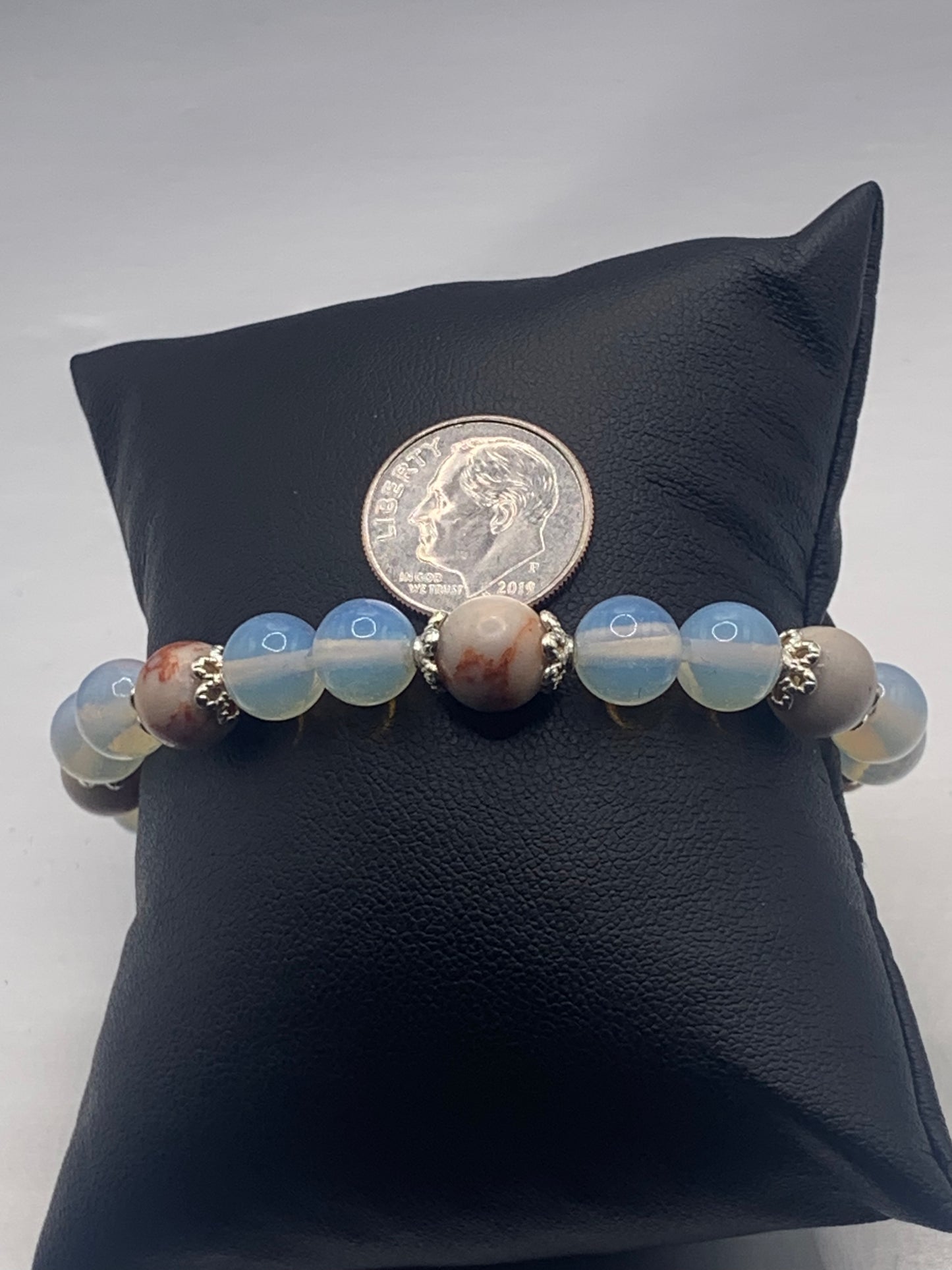 Red vein jasper and opalite semi precious stone/crystal elastic beaded bracelet with silver plated flower bead caps