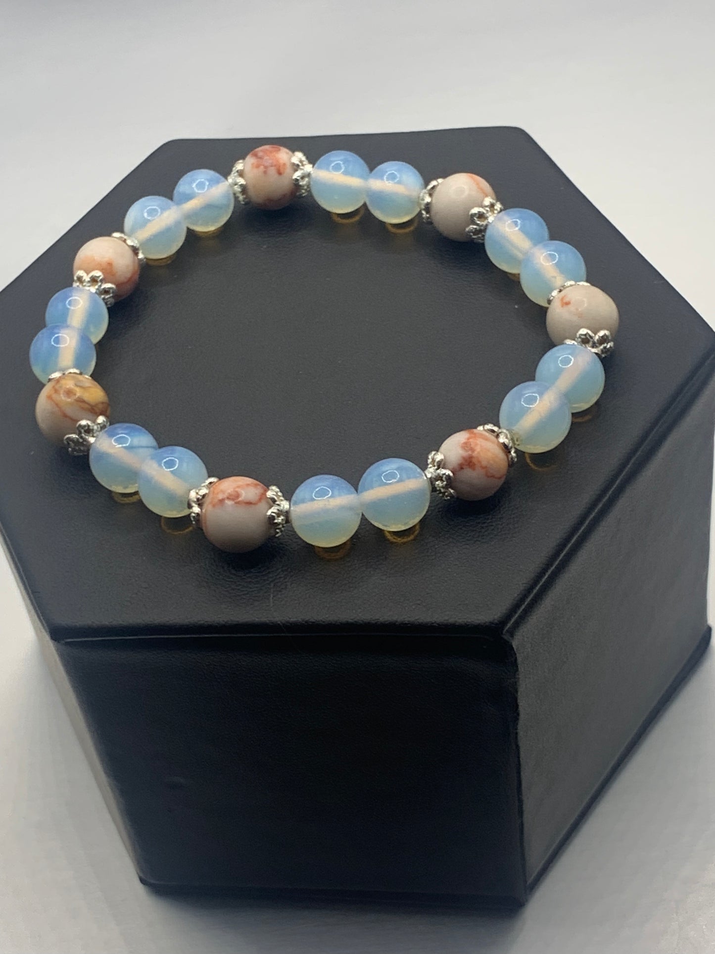 Red vein jasper and opalite semi precious stone/crystal elastic beaded bracelet with silver plated flower bead caps