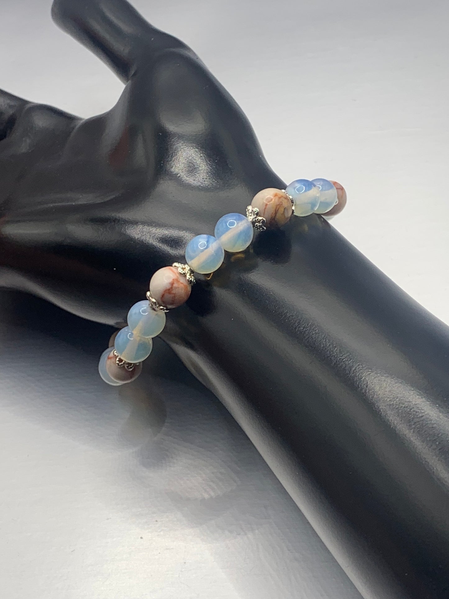 Red vein jasper and opalite semi precious stone/crystal elastic beaded bracelet with silver plated flower bead caps