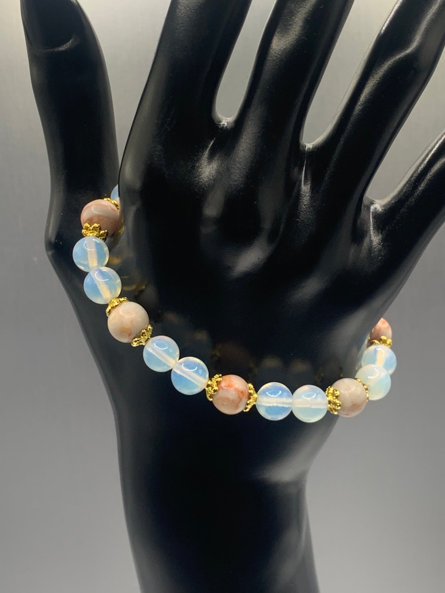Red vein jasper and opalite semi precious stone/crystal elastic beaded bracelet with gold plated flower bead caps