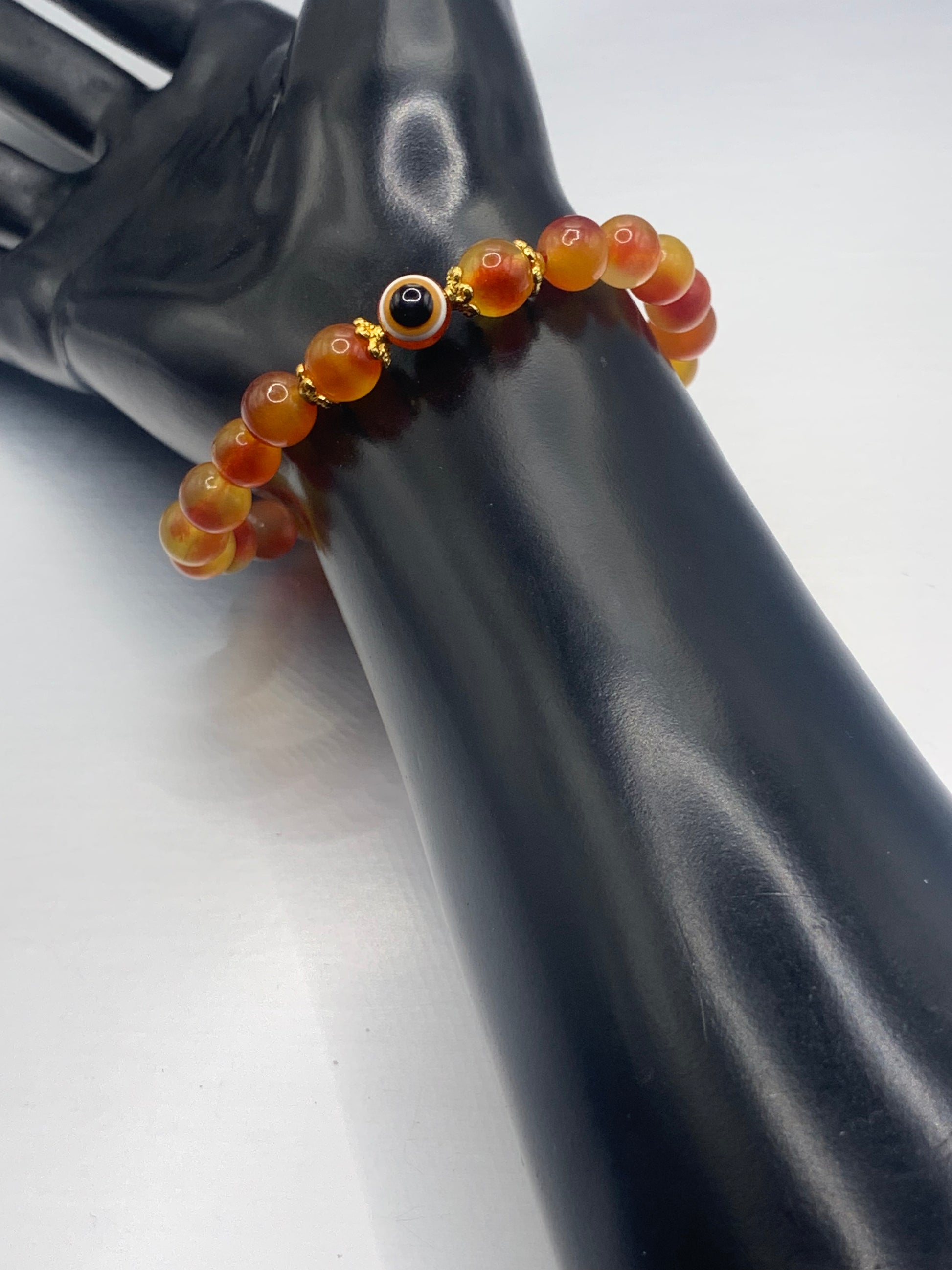 This bracelet features orange blossom agate beads and a colorful evil eye resin bead with gold flower caps. These are 8mm beads, made with elastic string to stretch onto the wrist and is approximately 17 cm or 6.7 inches



These are natural semi-precious stones/crystals. Even if they are dyed, the base material is still natural and imperfections are common making them unique