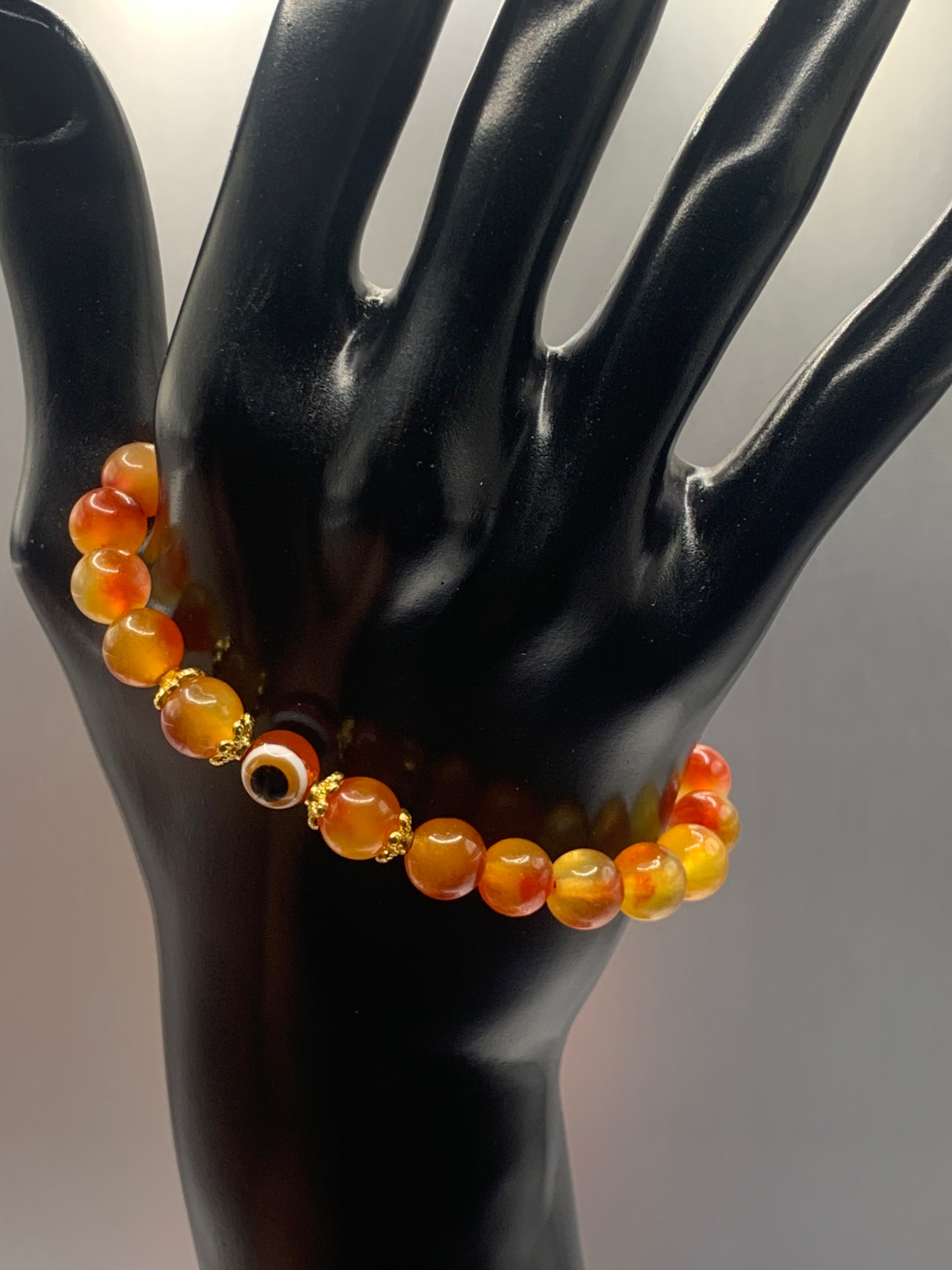 This bracelet features orange blossom agate beads and a colorful evil eye resin bead with gold flower caps. These are 8mm beads, made with elastic string to stretch onto the wrist and is approximately 17 cm or 6.7 inches



These are natural semi-precious stones/crystals. Even if they are dyed, the base material is still natural and imperfections are common making them unique