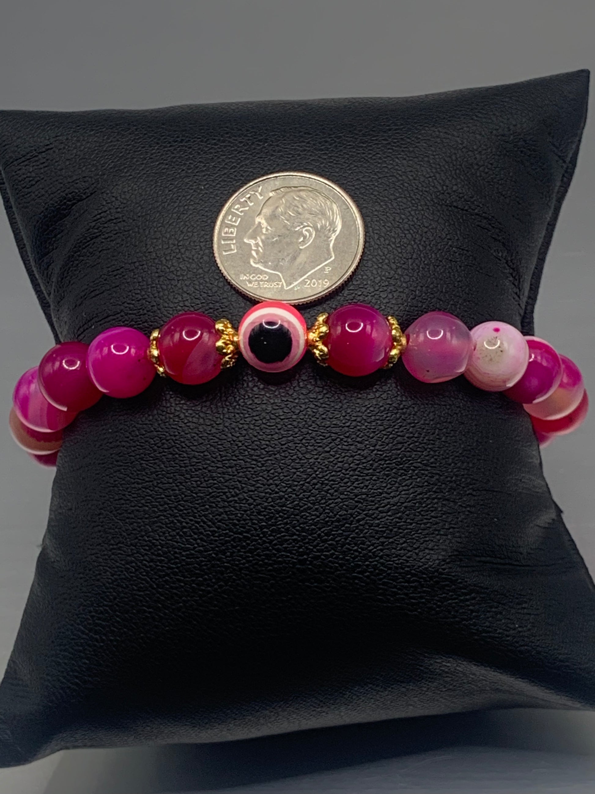 This bracelet features pink lace agate beads and a colorful evil eye resin bead with gold flower caps. These are 8mm beads, made with elastic string to stretch onto the wrist and is approximately 17 cm or 6.7 inches



These are natural semi-precious stones/crystals. Even if they are dyed, the base material is still natural and imperfections are common making them unique