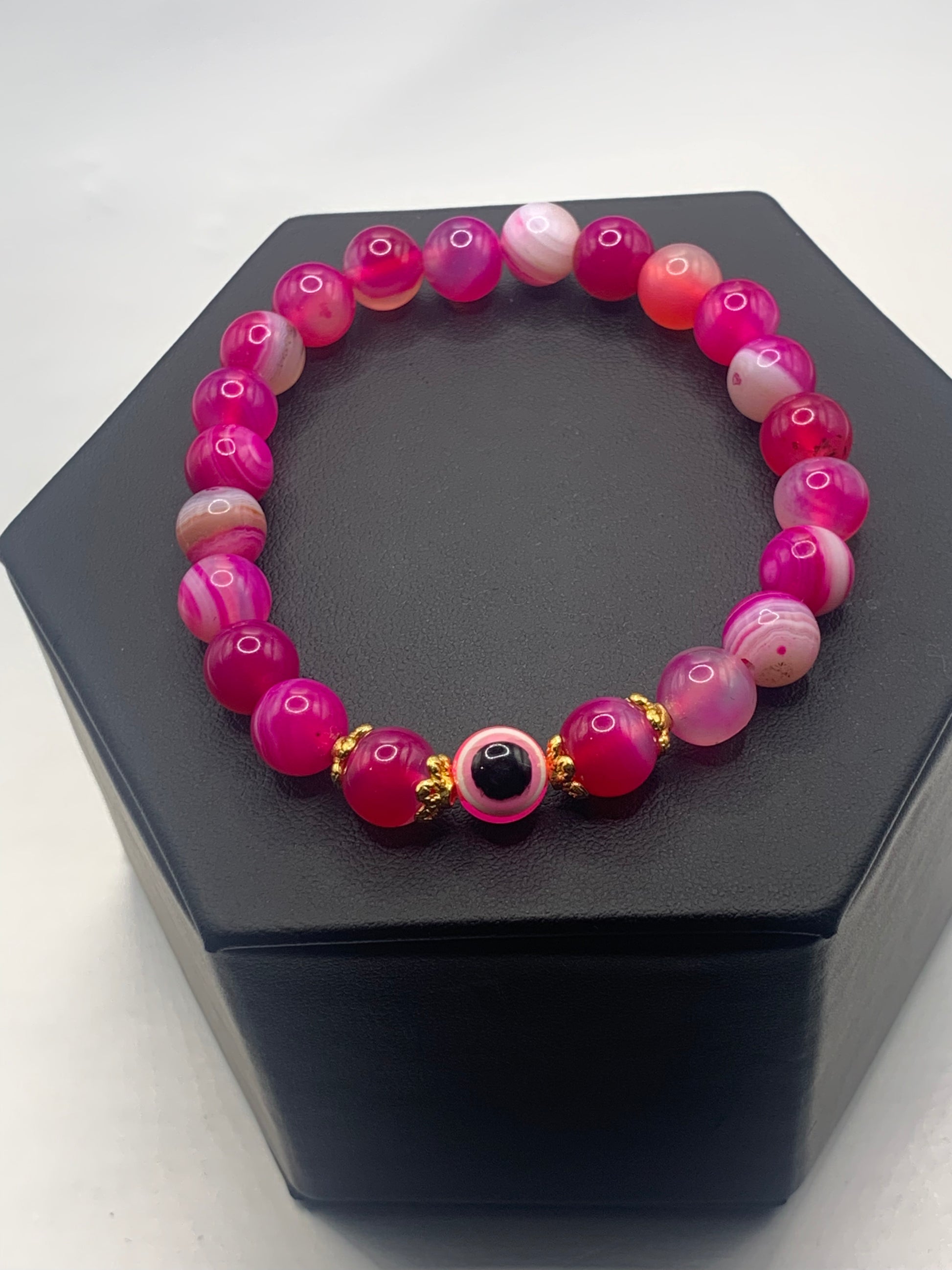 This bracelet features pink lace agate beads and a colorful evil eye resin bead with gold flower caps. These are 8mm beads, made with elastic string to stretch onto the wrist and is approximately 17 cm or 6.7 inches



These are natural semi-precious stones/crystals. Even if they are dyed, the base material is still natural and imperfections are common making them unique
