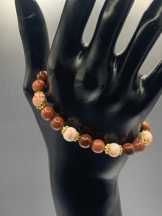 Red vein jasper and sandstone semi precious stone/crystal elastic beaded bracelet with gold plated flower bead caps