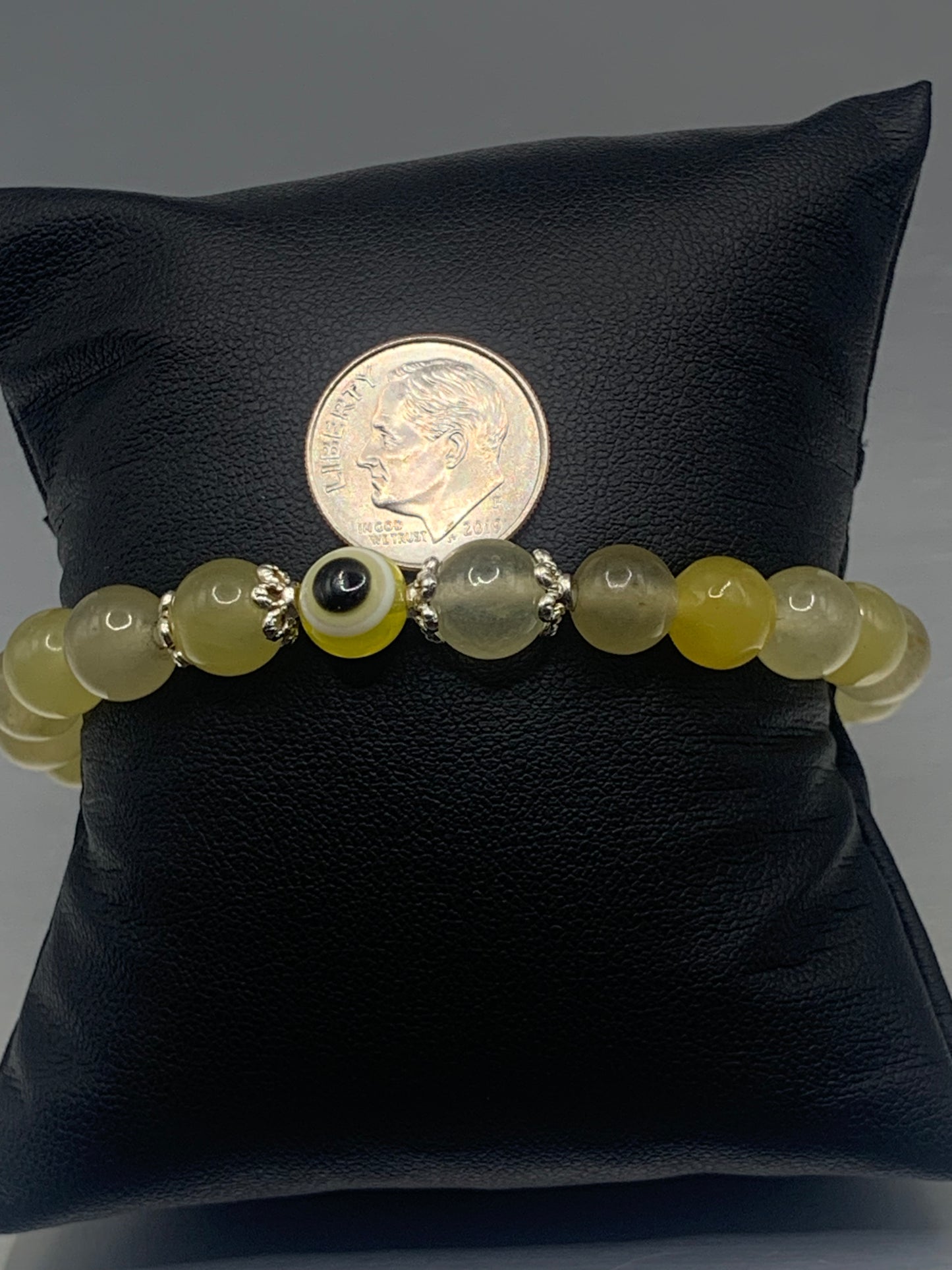 This bracelet features yellow agate beads and a colorful evil eye resin bead with silver flower caps. These are 8mm beads, made with elastic string to stretch onto the wrist and is approximately 17 cm or 6.7 inches


These are natural semi-precious stones/crystals. Even if they are dyed, the base material is still natural and imperfections are common making them unique
