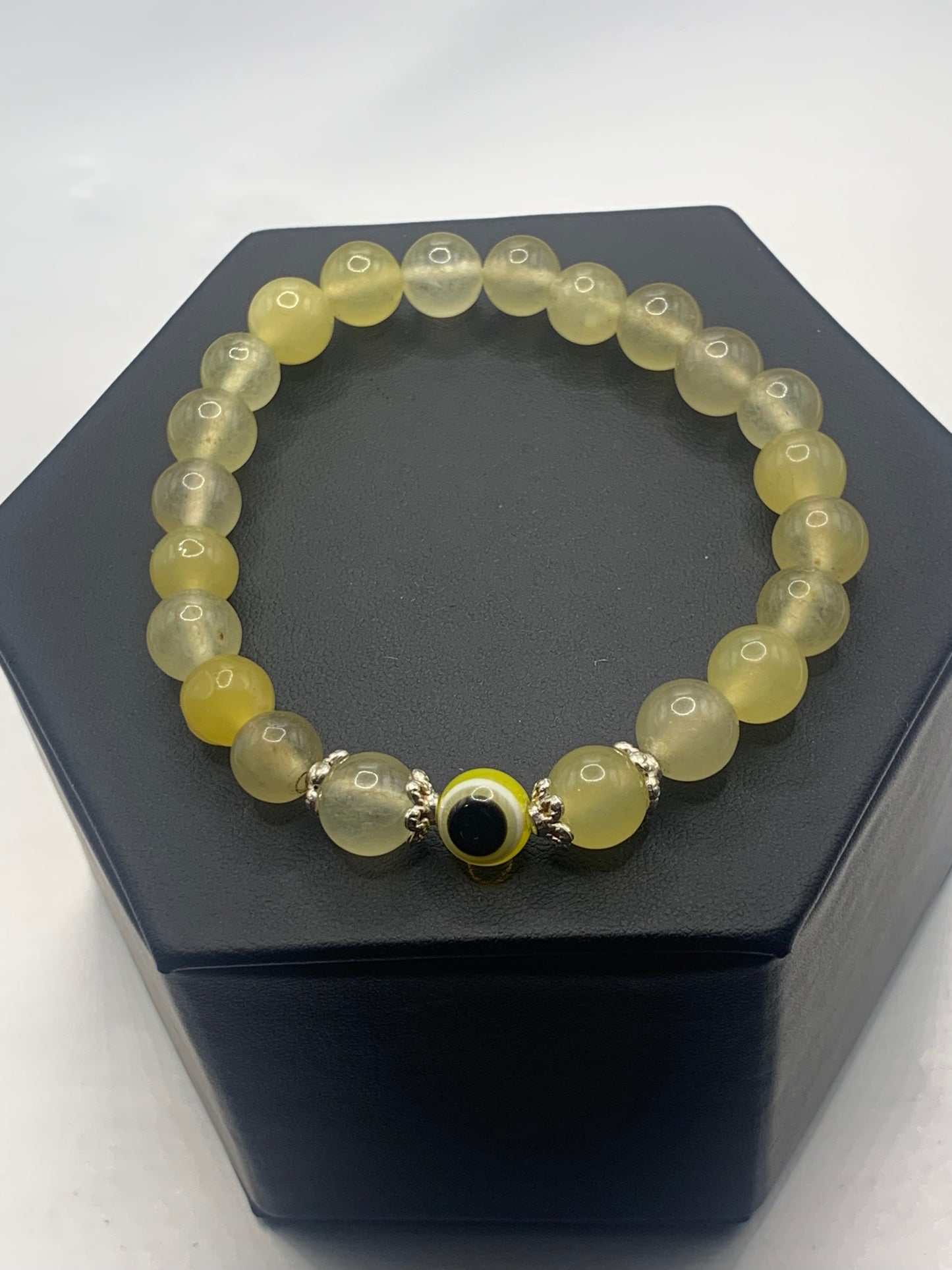 This bracelet features yellow agate beads and a colorful evil eye resin bead with silver flower caps. These are 8mm beads, made with elastic string to stretch onto the wrist and is approximately 17 cm or 6.7 inches


These are natural semi-precious stones/crystals. Even if they are dyed, the base material is still natural and imperfections are common making them unique