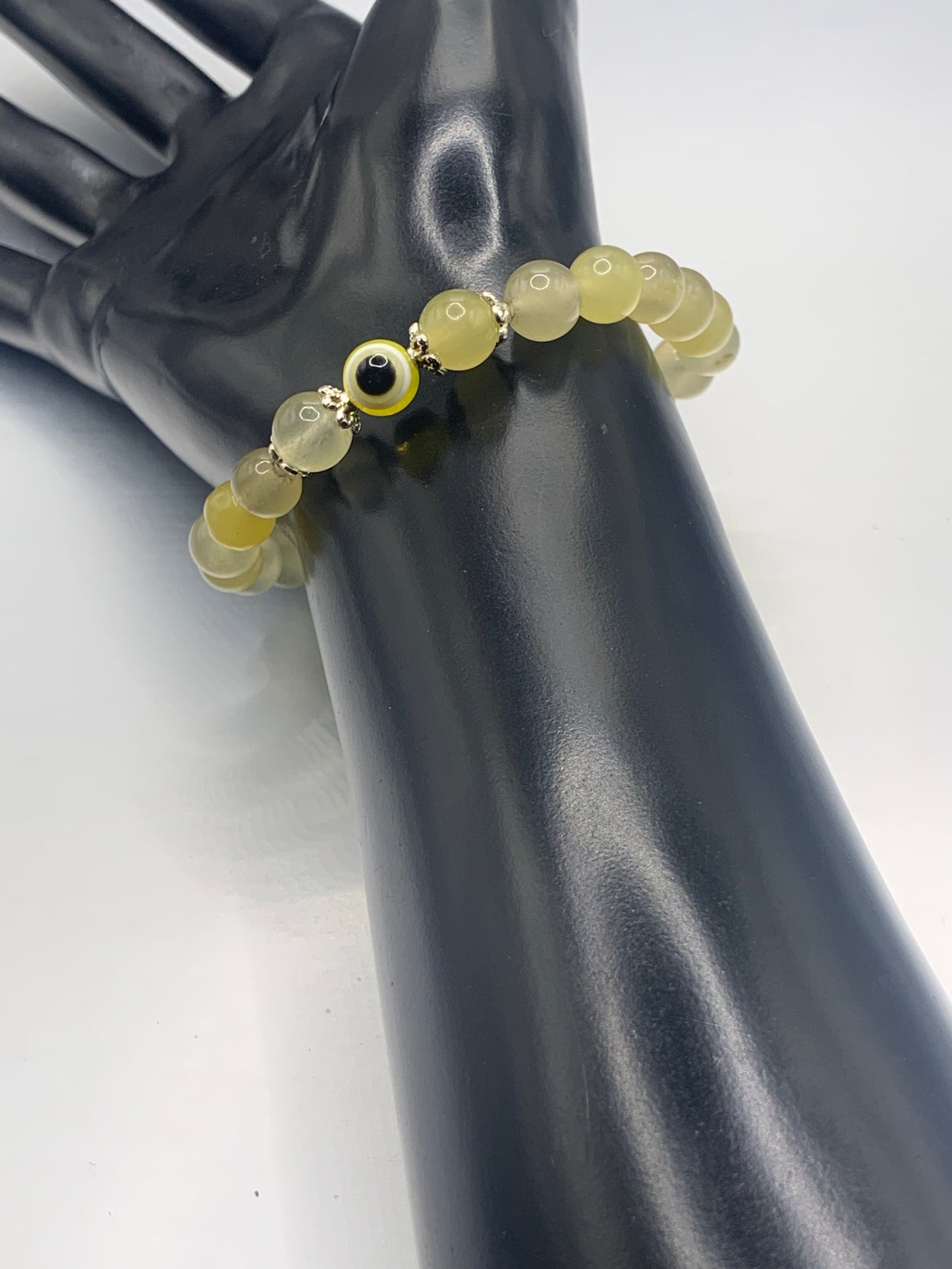 This bracelet features yellow agate beads and a colorful evil eye resin bead with silver flower caps. These are 8mm beads, made with elastic string to stretch onto the wrist and is approximately 17 cm or 6.7 inches


These are natural semi-precious stones/crystals. Even if they are dyed, the base material is still natural and imperfections are common making them unique