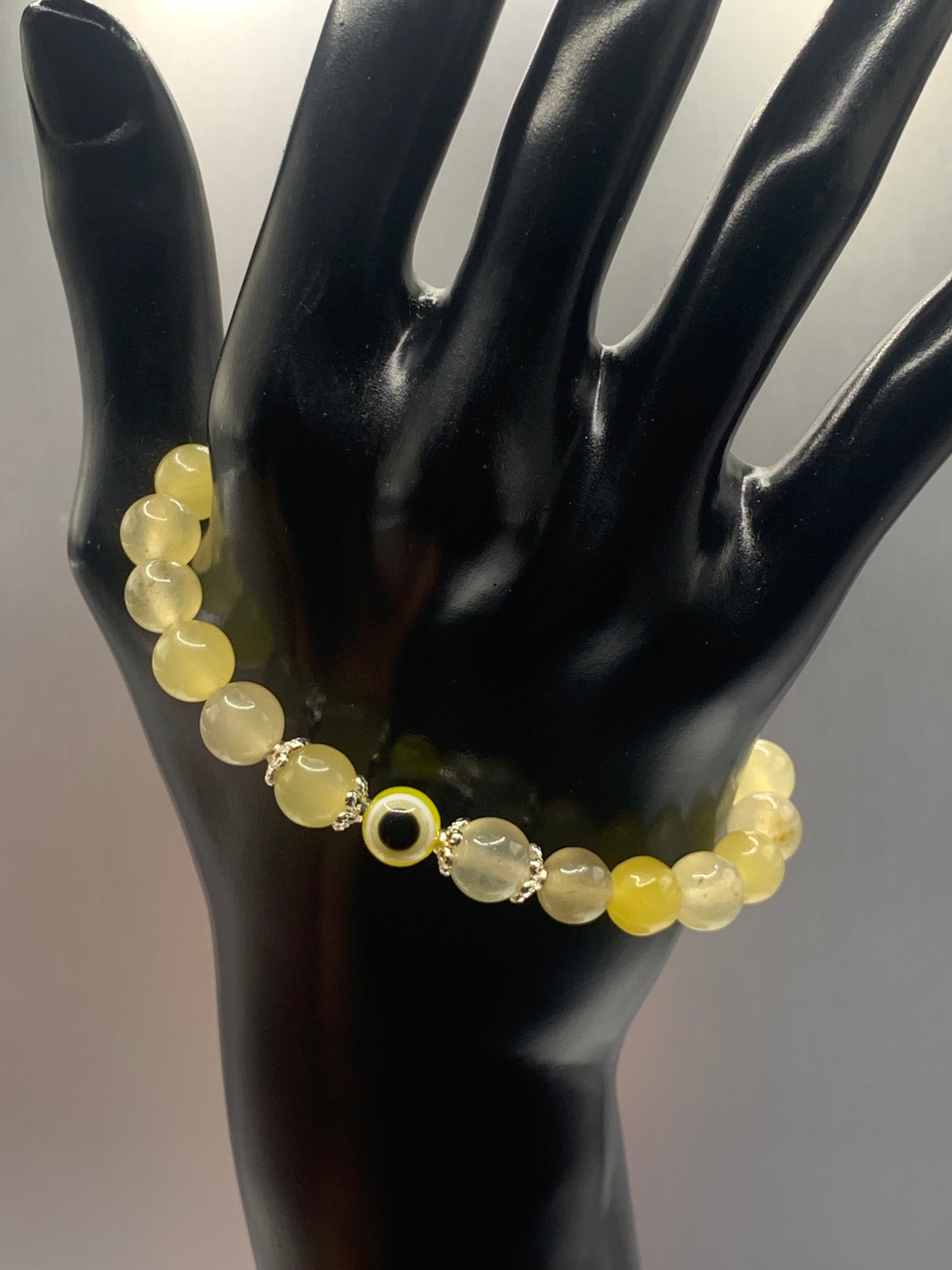 This bracelet features yellow agate beads and a colorful evil eye resin bead with silver flower caps. These are 8mm beads, made with elastic string to stretch onto the wrist and is approximately 17 cm or 6.7 inches


These are natural semi-precious stones/crystals. Even if they are dyed, the base material is still natural and imperfections are common making them unique