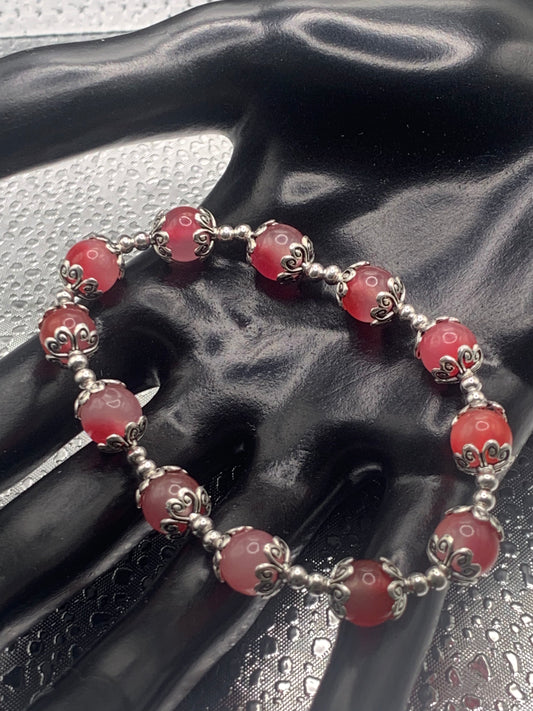 This bracelet contains hot pink agate beads that are surrounded by bead caps and spacer beads