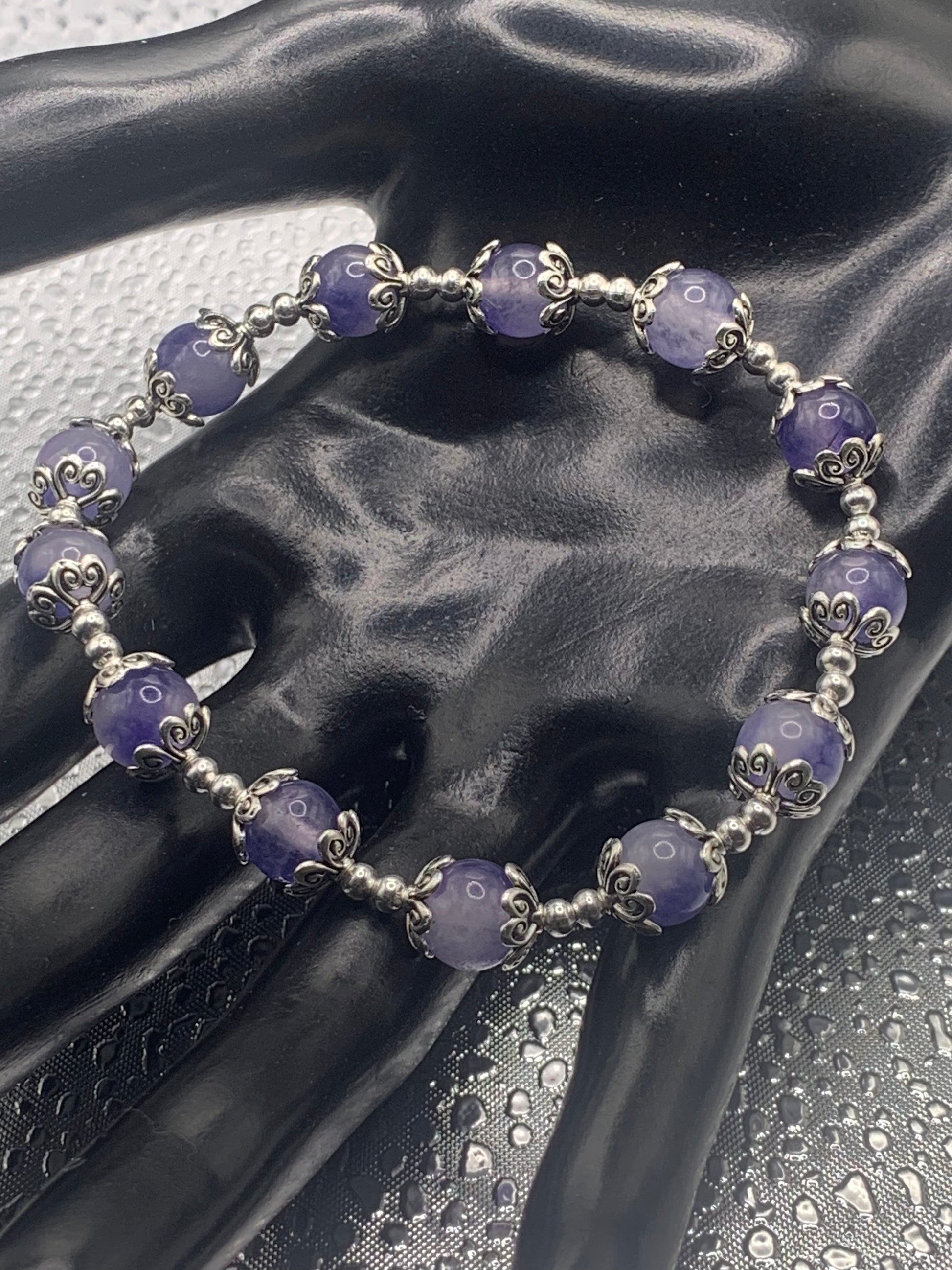This bracelet contains ice blue agate beads that are surrounded by bead caps and spacer beads