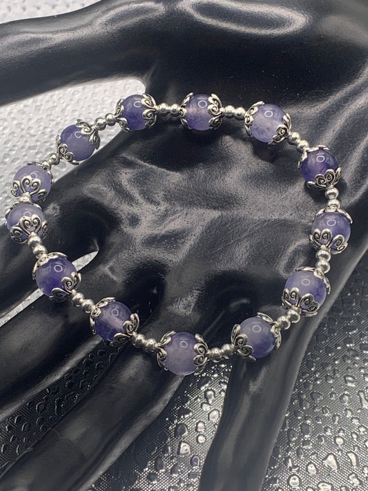 This bracelet contains ice blue agate beads that are surrounded by bead caps and spacer beads