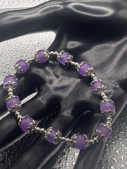 This bracelet contains lavender agate beads that are surrounded by bead caps and spacer beads