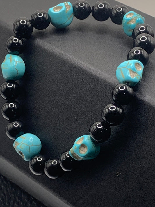Black obsidian semi precious stone/crystal elastic beaded bracelet with teal resin skulls