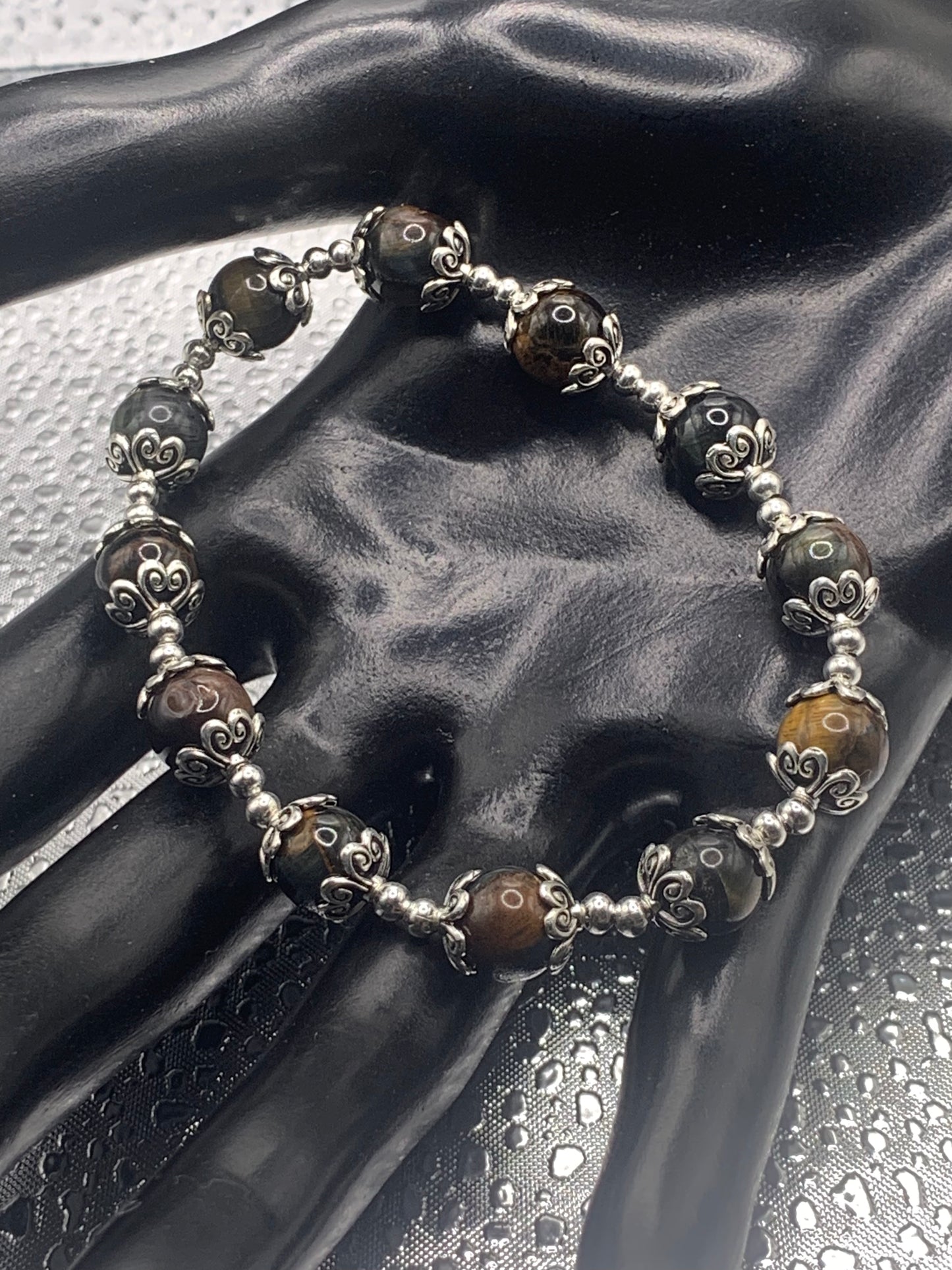 This bracelet contains tigers eye beads that are surrounded by bead caps and spacer beads