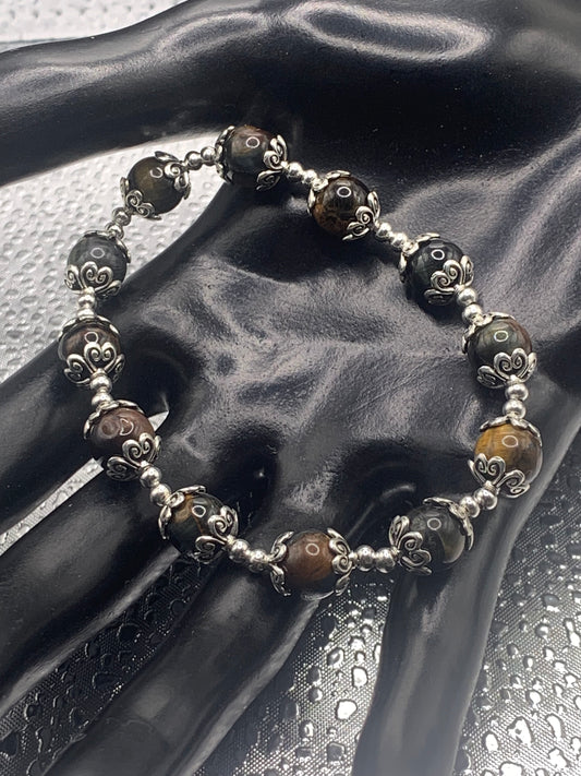This bracelet contains tigers eye beads that are surrounded by bead caps and spacer beads
